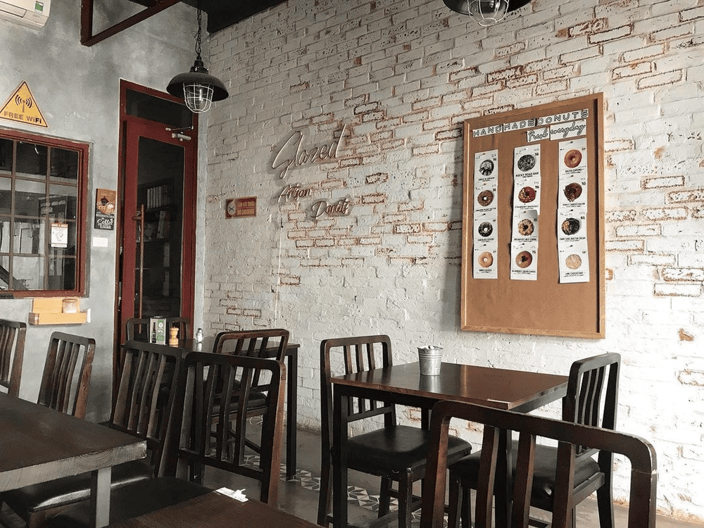 The seating area features walls painted with colorful graphic art (Source: Lifted Coffee & Brunch)